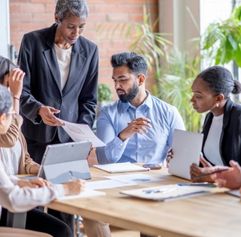 professionals of varying ages and backgrounds collaborating in an office