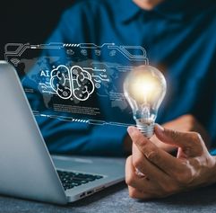 person holding a light bulb in front of AI computer