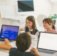 young students coding on computers