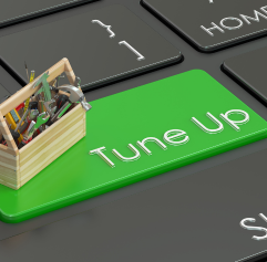 a black computer keyboard that has a 'tune up' button on it