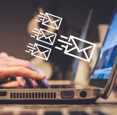 someone typing on a computer with envelope graphics across the screen