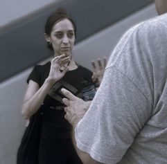 a woman putting up both arms prepared to defend herself