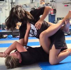 a woman putting up both arms prepared to defend herself
