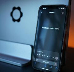 a phone with AI on the screen asking what it can help with