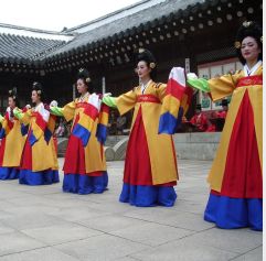 korean women in traditional dress in front of building