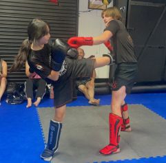 two teens practicing muay thai moves