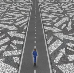 business man on a road with arrows surrounding him