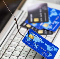 a credit card with a fish hook in it being pulled