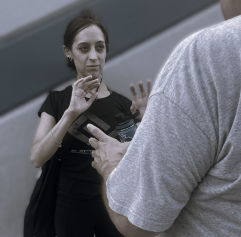adults practicing a self defense move
