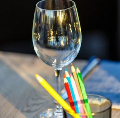 adults painting while drinking wine