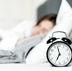 ya woman sleeping and a clock in the foreground