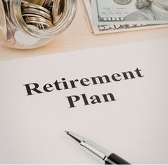 document that says 'retirement plan' on it with a pen