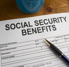 a social security benefits form and a pen on top of it