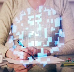 an adult writing with a pencil with a digital brain in front of them